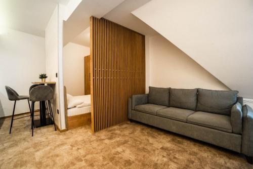 a living room with a couch and a bed at Apartments Suncani Vrhovi Kopaonik in Kopaonik