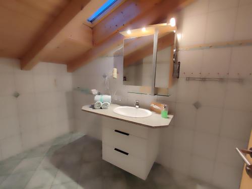 a bathroom with a sink and a mirror at Haus Kristall in Alpbach
