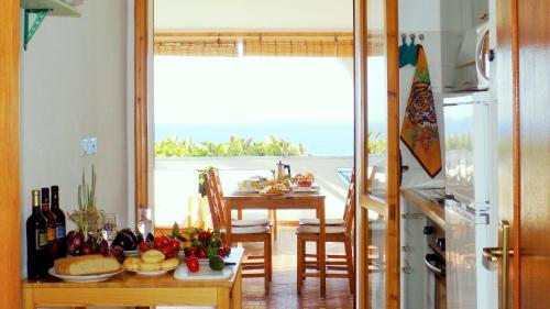 a kitchen with a table with a view of the ocean at Le Case di Concetta in Santa Maria