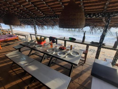 a table with plates of food on the beach at Indika Beach Villa in Galle