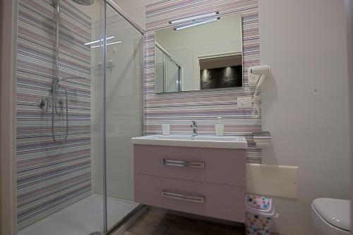 a bathroom with a sink and a shower at Al Teatro Suites in Foggia