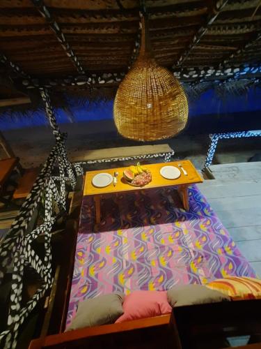 a table on a bed in a room with a tableablish at Indika Beach Villa in Galle
