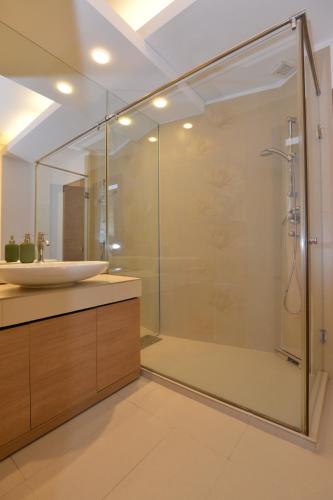 a bathroom with a glass shower and a sink at Old Town Apartment Lipscani in Bucharest