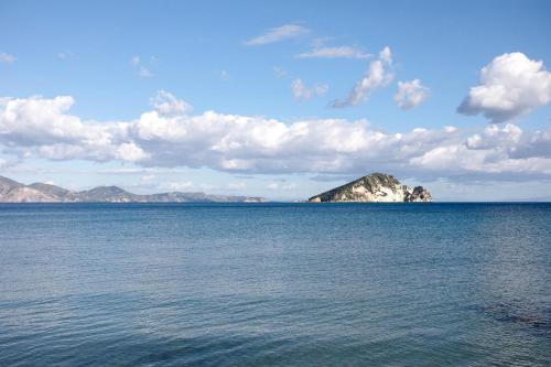 a large body of water with a mountain in the distance at Dolphin Apartment 8 in Keri