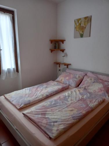 a bed sitting in a bedroom with at Casa Luca in Tremosine Sul Garda
