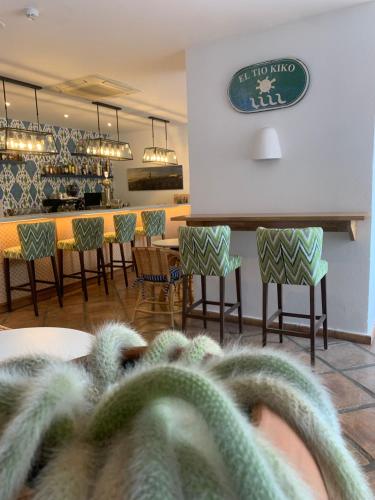 a person with their feet up on a table in a restaurant at Boutique Hotel El Tio Kiko in Agua Amarga