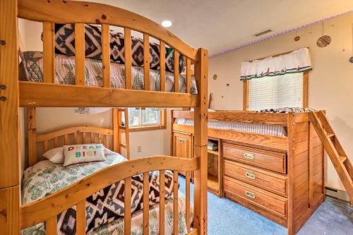 a bedroom with two bunk beds and a desk at Game Room and Lake Access Albrightsville Home! in Albrightsville