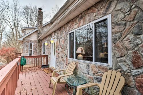 a stone house with two chairs on a patio at Game Room and Lake Access Albrightsville Home! in Albrightsville