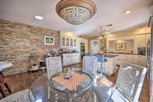 a kitchen with a glass table and some chairs at Stunning Rogers Villa with Pond about 7 Mi to Lake in Rogers