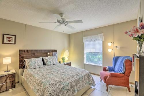 a bedroom with a bed and a ceiling fan and a chair at Keaton Beach Escape with Hot Tub 2 Mi to Shore in Perry