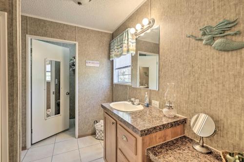 a bathroom with a sink and a mirror at Keaton Beach Escape with Hot Tub 2 Mi to Shore in Perry
