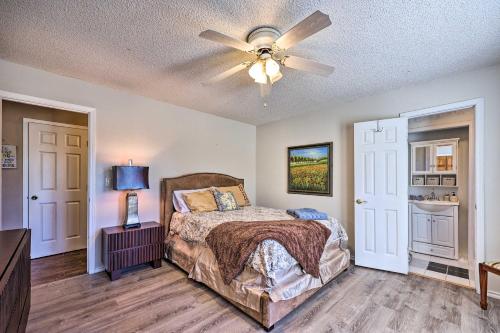 a bedroom with a bed and a ceiling fan at Stunning Rogers Villa with Pond about 7 Mi to Lake in Rogers