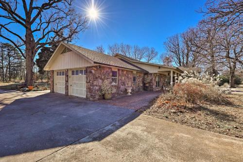 a brick house with a garage on a driveway at Stunning Rogers Villa with Pond about 7 Mi to Lake in Rogers