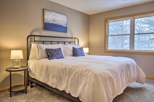 a bedroom with a bed and a window at Lakefront Minocqua Getaway Dock, Game Room! in Minocqua