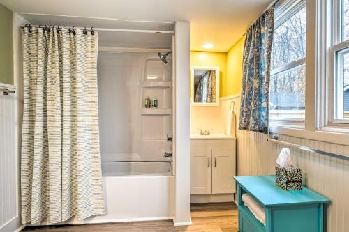 a bathroom with a tub and a shower curtain at Peaceful Indianapolis Retreat 20 Min to Dtwn in Indianapolis
