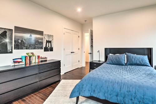 a bedroom with a blue bed and a dresser at Grand Long Branch Home 1 Block to Beach! in Long Branch