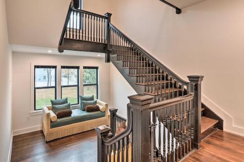 a living room with a staircase with a couch and a chair at Grand Long Branch Home 1 Block to Beach! in Long Branch