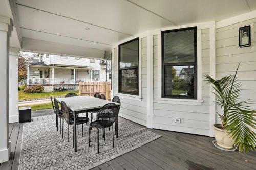 a patio with a table and chairs on a house at Grand Long Branch Home 1 Block to Beach! in Long Branch