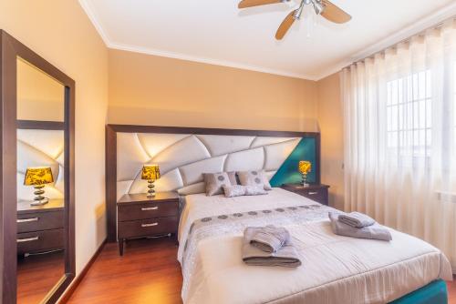 a bedroom with a large bed with two towels on it at Boa Vida Alojamentos in Vagos