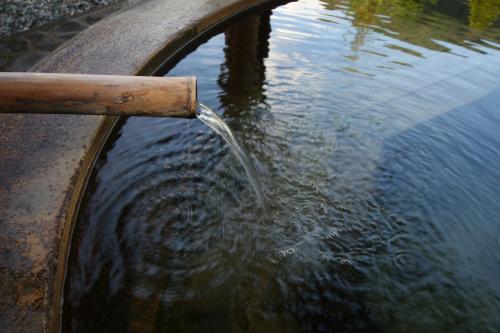 a water fountain with water coming out of it at Nakamurakan in Takayama