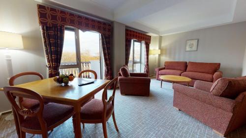 a living room with a table and a couch at Coppid Beech in Bracknell
