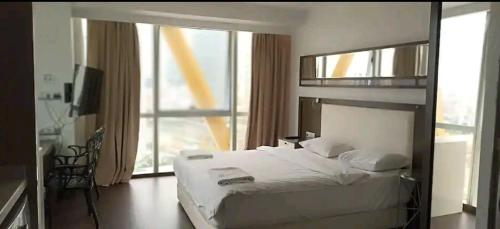 a bedroom with a large bed and a large window at SBK HOTEL in Istanbul