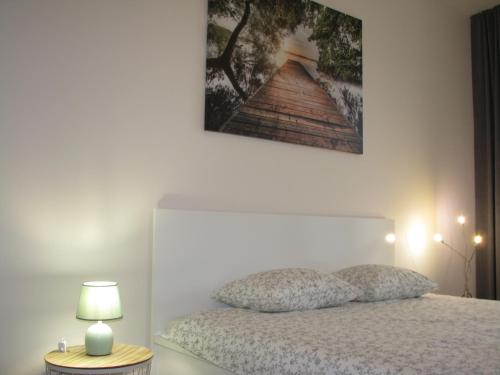 um quarto com uma cama e uma fotografia na parede em 4You Apartament em Bialystok