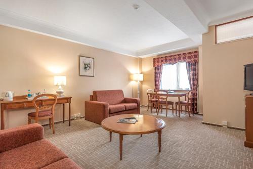 a living room with a couch and a table at Coppid Beech in Bracknell