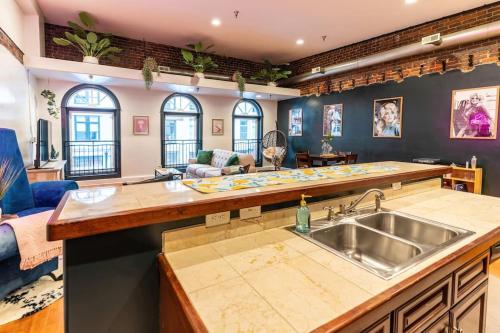 a kitchen with a sink and a living room at Jolene's Hideout in Knoxville