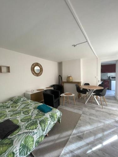 une chambre avec un lit, une table et des chaises dans l'établissement Le Victor Hugo, à Besançon