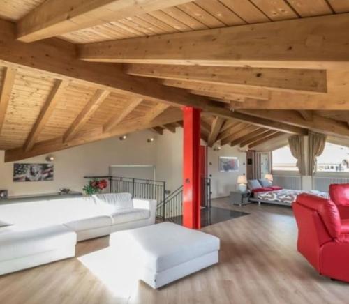 a living room with a white couch and red chairs at Villa (Le Calle) Brezza del Lago - Tremezzina. in Mezzegra