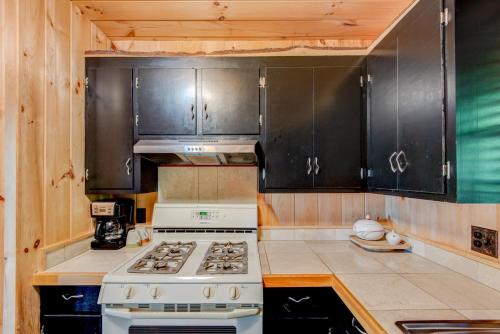 a kitchen with a stove and black cabinets at Crystal View in Valle Crucis