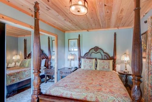 a bedroom with two beds and a wooden ceiling at Crystal View in Valle Crucis