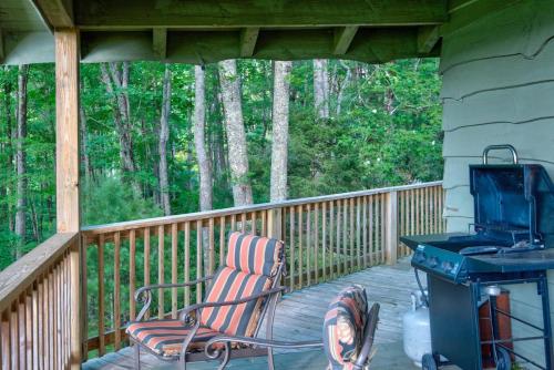 a patio with a chair and a grill on a porch at Crystal View in Valle Crucis