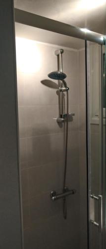 a shower with a glass door in a bathroom at Loutraki-SPA-Apartment in Loutraki