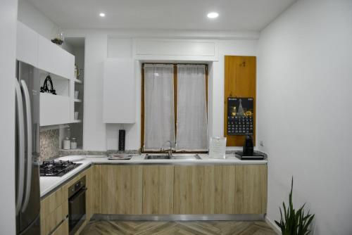 a kitchen with a sink and a counter top at Salifornia casa vacanze in Salerno