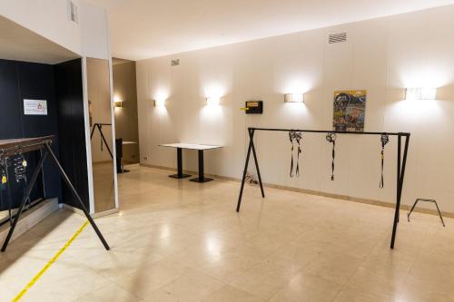 a room with a table and a room with some jewelry at Hotel Can Pamplona in Vic