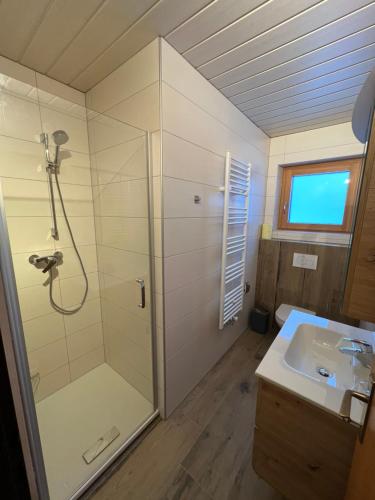 a bathroom with a shower and a sink at Gästehaus Wallner in Presseggen