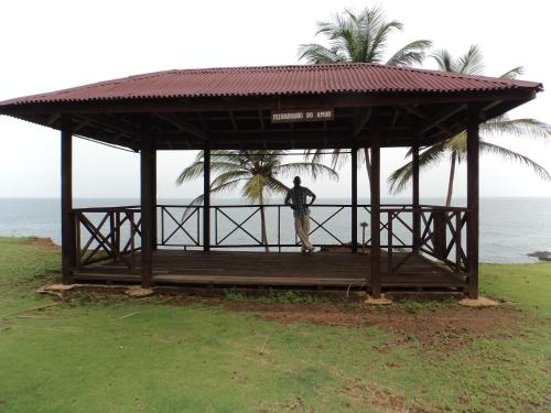 a man standing in a gazebo next to the ocean at Jardim Botânico ME-ZOCHI in Vila Moura