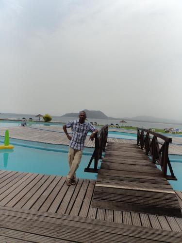 a man walking down a wooden boardwalk at Jardim Botânico ME-ZOCHI in Vila Moura