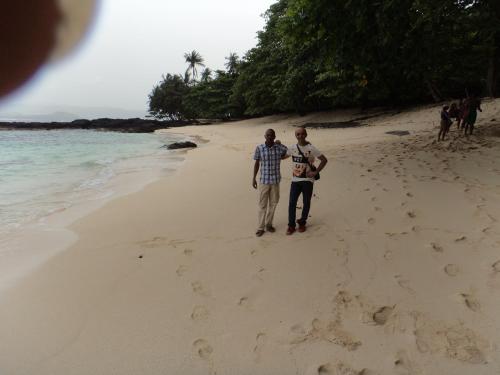 two men are standing on the beach at Jardim Botânico ME-ZOCHI in Vila Moura