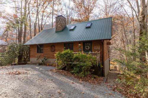 a cabin in the woods with a gravel driveway at Draggin Fly in Valle Crucis