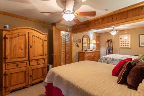a bedroom with a large bed and a wooden cabinet at Draggin Fly in Valle Crucis