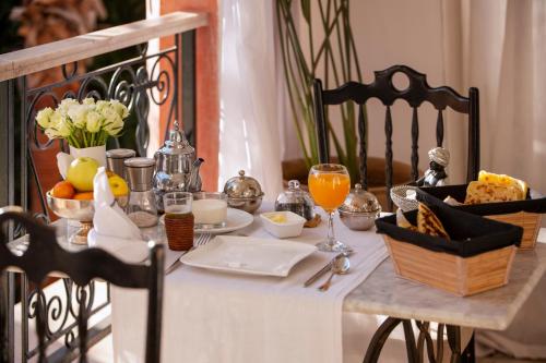 a table with a breakfast of food and orange juice at Indian Palace in Marrakech