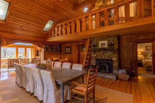 a dining room with a table and a fireplace at Beech Haven in Beech Mountain