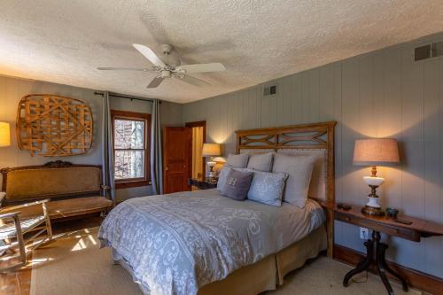 a bedroom with a bed and a ceiling fan at Beech Haven in Beech Mountain