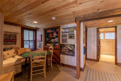 a living room with a table and a couch at Beech Haven in Beech Mountain