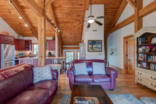 a living room with two couches and a table at Muir Lodge in Blowing Rock