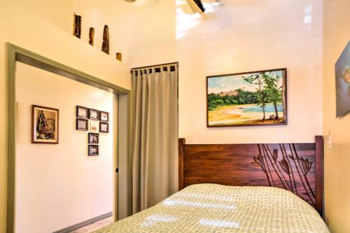 a bedroom with a bed with a wooden headboard at Pristine Lihue Condo with Balcony Walk to Beach! in Lihue