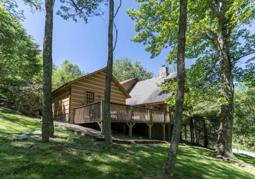 a log cabin in the woods with trees at Almost Heaven in Sugar Grove